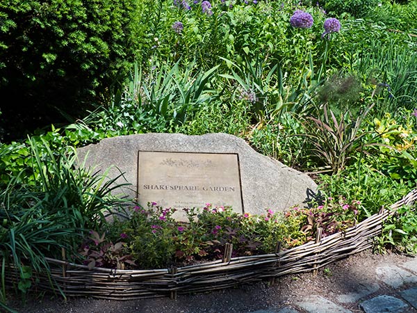 A subtle plaque set into a stone marks the entrance to the garden.